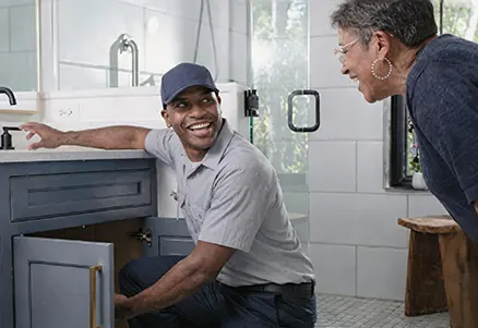 Professional certified plumber fixing pipe