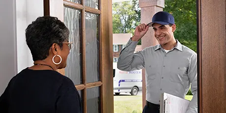 Vetted local technician greeting customer at door